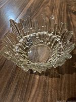 Top-down view showing the jagged spiked rim with one broken point and smooth bowl interior.