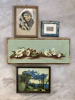 Lot of four vintage framed pictures displayed on floor including portrait of boy with puppy, floral paintings and Venice street scene