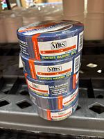 Stack of five rolls of MBS brand painter's masking tape showing label with product and usage details.