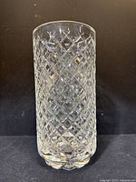Full view of clear Waterford crystal glass vase with diamond cut pattern on black background.