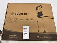 Packaged Beloems bed rail box showing brand name and product features including ergonomic design, motion sensor light, and easy assembly.
