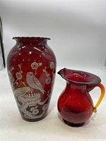 Photo of red glass bird vase and red crackle glass mini pitcher showing overall appearance and details.
