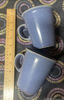Two blue speckled mugs with a ruler for size reference showing just under 4.5 inches tall.