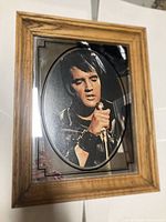 Full view of the framed glass portrait of Elvis Presley, showing wood frame and oval image.