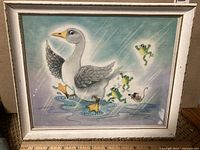 Framed vintage illustration of a duck surrounded by frogs and a mouse on a blue background.