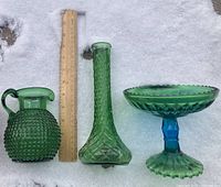 All three green glass items together with ruler for scale in snow background.