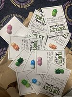 Photo showing 15 small turtle figurines in different colors attached to white cards with the inspirational message