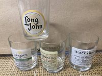 Set of four whiskey glasses showing all labels: Long John, Usher's Green Stripe, Hudson's Bay, Black & White Buchanan's Old Scotch Whisky