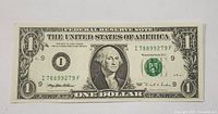 Front of 1995 US one dollar bill showing George Washington and serial number.