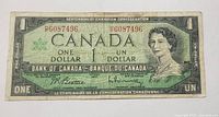 Front view of the 1967 Canadian Centennial One Dollar bill showing Queen Elizabeth II, serial number 6087496, and bilingual text.