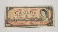 Front view of the 1954 Bank of Canada two-dollar note, featuring Queen Elizabeth II portrait, denomination in English and French, and serial number with T/G prefix.