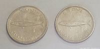Both dimes showing reverse side with silver mackerel design and inscriptions.