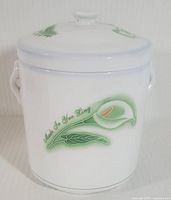 Front view of white porcelain canister showing floral design and 'Made In Hong Kong' marking.