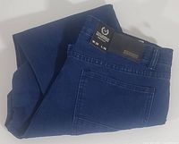 Dark blue folded jeans shown front and back with visible pocket and waistband details.