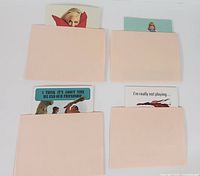 Four vintage Playboy greeting cards partially revealed inside matching envelopes showing card designs and text phrases