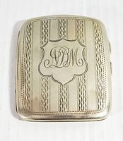 Front of vintage EPNS silver plate rectangular case with monogram LDM and decorative etched design