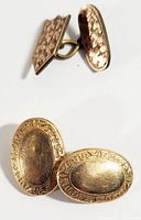 Pair of vintage gold-tone cufflinks front and back showing detailed engraving and hinged bar backs.