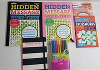 Full view of all 4 puzzle books and pack of felt tip markers on white background.