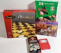 Photo of all 5 items in the activity set showing the checkers game, two puzzles, dominoes, and playing cards.