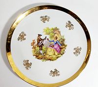 Top-down photo of the entire 13-inch diameter plate showing the full scene, gold accents and rim.