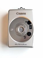 Front view of the Canon ELPH LT260 film camera showing the lens and brand markings.