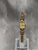 Full view of vintage Elgin ladies mechanical watch with gold filled bracelet on display stand