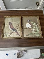 Full view of both framed paintings together showing composition and frame detail