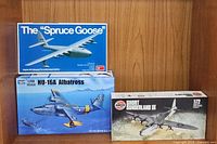 Three boxed airplane model kits showing artwork and scale details: Spruce Goose, HU-16A Albatross, and Short Sunderland III.