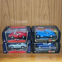 All four Bburago diecast model cars in original packaging, side-by-side display.