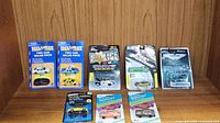 Close-up of Road & Track two-car value packs displaying detailed vehicle models and colorful packaging.