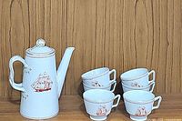 Full lot image showing 1 tea/coffee pot and six teacups grouped with three saucers.