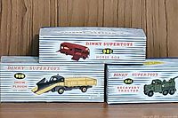 Three Dinky Supertoys original striped boxes showing the 958 Snow Plough, 981 Horse Box, and 661 Recovery Tractor design on packaging.