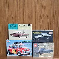 Photo of all four model car kits stacked: 1962 Chrysler Imperial Crown by Revell, 1962 Rolls-Royce Silver Cloud II by Minicraft, 1962 Chevy Impala SS by AMT, and Morris Mini Cooper 1275S Rally by Tamiya.
