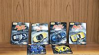 Five Maisto Power Racers die-cast cars in original blister packs on wooden background, showing variety and condition of the lot.