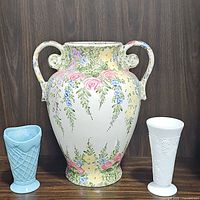 Set of three vases on wooden backdrop showing relative sizes and details