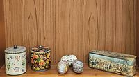 Wide shot showing all tins and decorative tin eggs on shelf