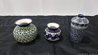 Front view of the three Polish pottery vases showing shape and pattern detail