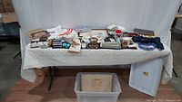 Wide view of all Exxon/Esso memorabilia items displayed on a table, showing a variety of promotional products, plaques, bags, and tiger motif items.