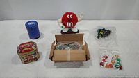 Photo of entire M&M memorabilia lot arranged on white surface, showing all items included in the lot.