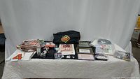 Full view of all memorabilia items laid out on a table including bags, framed photos, apparel, and assorted collectibles