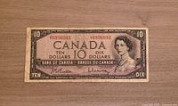 Front side of the 1954 Canadian $10 banknote showing portrait of Queen Elizabeth II, denomination, serial number, and Bank of Canada markings.