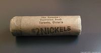 Photo of the sealed paper roll containing the coins with bank label visible