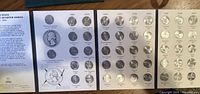 Open coin folder displaying the set of 50 state quarters from 1999 to 2008 by year and state, showing detailed quarter designs.