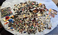 Wide view of entire lot showing loose bricks, parts, minifigures and manuals