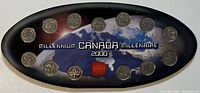 Full view of all 13 Canadian Millennium quarters displayed in original black oval case showing Earth and space background, labeled Millennium Canada 2000 Millénaire.