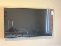 Front view of LG 65" TV mounted on wall