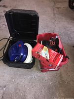 Simoniz polisher with buffing pad inside black plastic case; red toolbox with Mothers Nulens headlight renewal kit and Jobmate polisher visible beside it