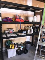 Front view of entire shelving unit with items placed for scale