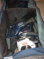 Photo showing Ryobi 18V circular saw and reciprocating saw inside a tool bag.