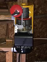 Front view of the electric winch showing the cable spool, red safety plate, and cable hook.